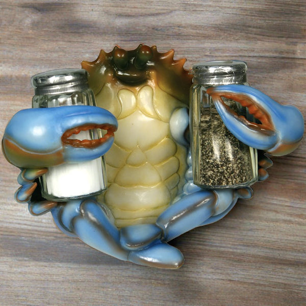 crab holding salt and pepper shakers